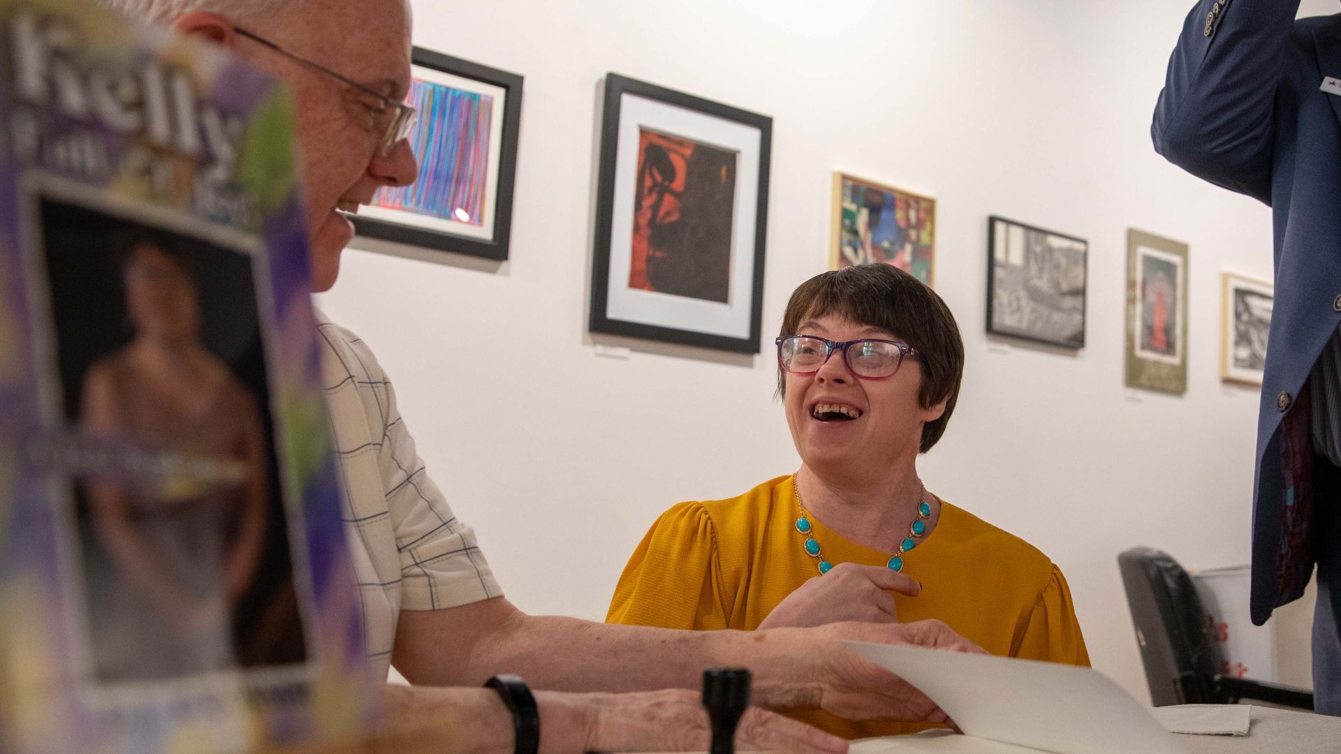 Two people talking and smiling